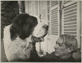 A large dog faces Picasso on a chair