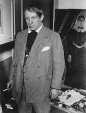 Brassaï, photo of Picasso in his studio at 23 rue La Boétie, standing in front of Rousseau's Portrait of a Woman 1932